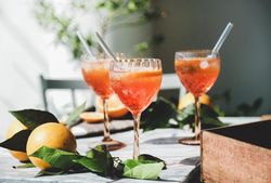 Three Aperol Spritz aperitif alcohol drink in glasses, horizontal