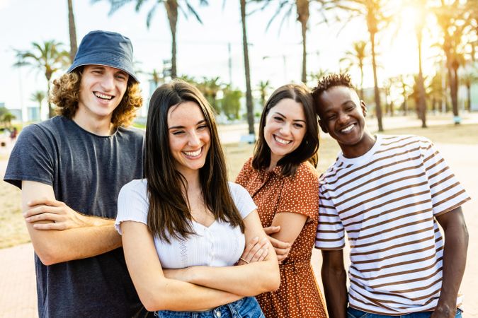 Group of happy multiracial friends posing outdoors