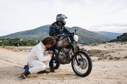 Mechanic checking motorcyclist bike engine