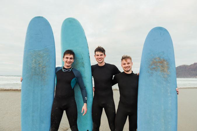 Excited men with surfboards