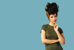 Studio shoot of curious Black woman on blue background