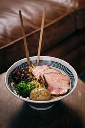 Bowl of delicious ramen soup served in restaurant