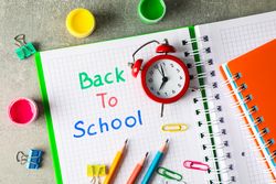 Composition with school supplies on grey background, top view
