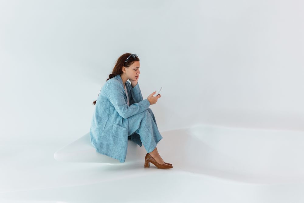 Woman browsing smartphone in studio