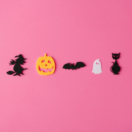 Row of witch, pumpkin, nat, ghost and cat with ghosts on pink background