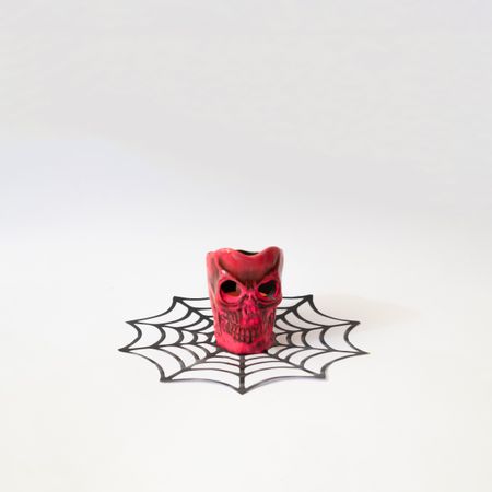 Red skull in dark ice cream cone in halloween concept