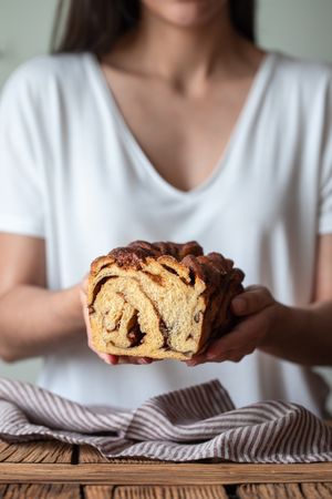 Faceless woman with appetizing cinnamon babka