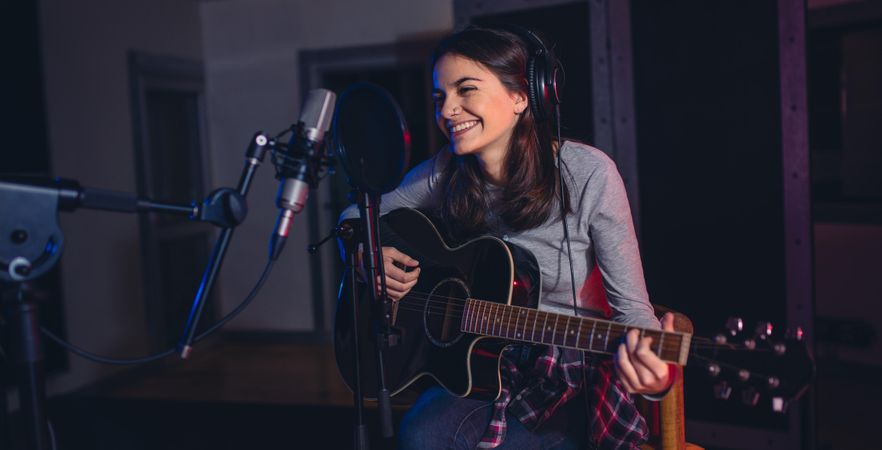 Woman performing in a recording studio recording an album