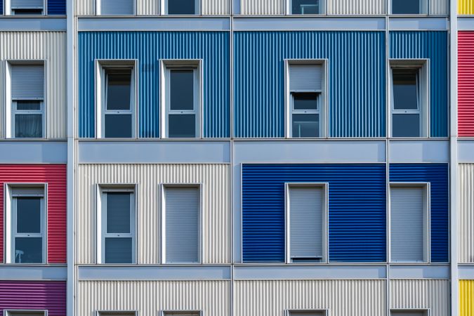 Facade of modern multicolored building with narrow windows