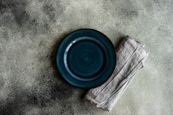 Top view of table setting with elegant dark blue plate