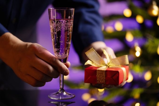 Businessman Holding Gift And Champagne Glass