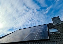 Solar panels producing clean energy on a roof of a residential house