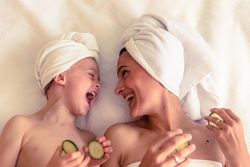 Laughing mother and son having spa session