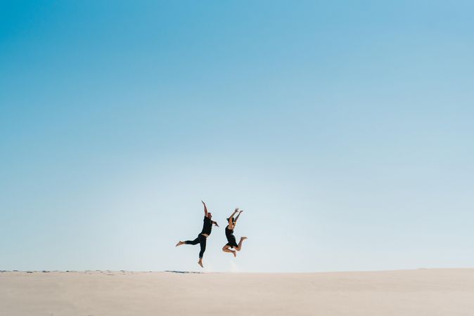 Man and woman jumping in the air