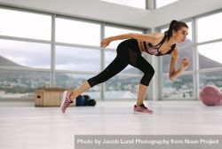Female in a stretching pose at fitness studio 0KM8wN