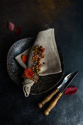 Top view of autumnal table setting with amber leaves