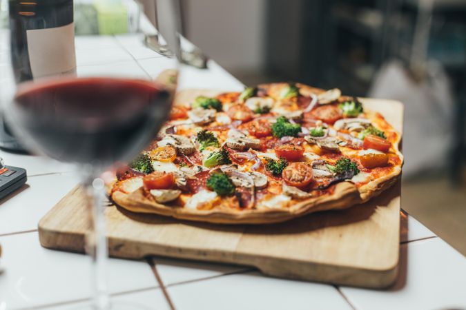 Pizza with red wine in foreground