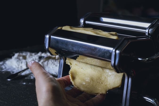 Housewife preparing homemade pasta with pasta machine