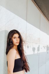 Female standing near wall