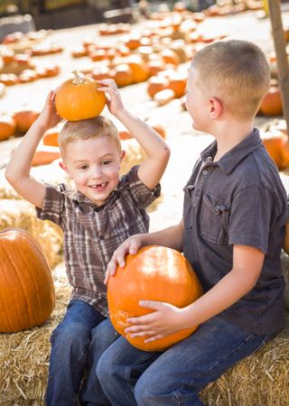 Two Boys at the Pumpkin Patch Talking and Having Fun.