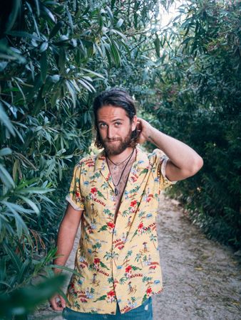 Hipster man walking in the jungle