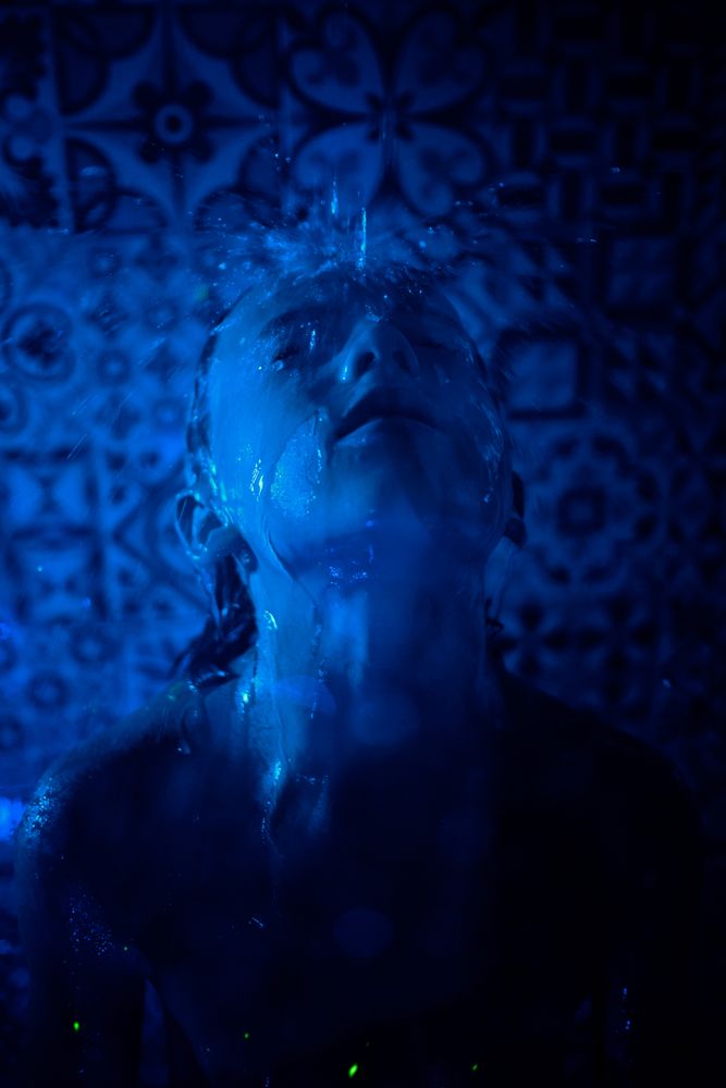 Child under water flow in shower room
