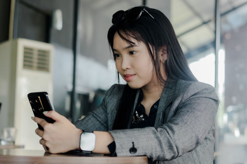 Young professional checking digital devices in a modern office