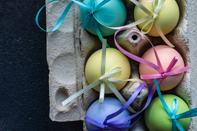 Top view of decorative pastel Easter eggs with ribbons
