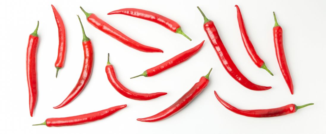 Flat lay with chilli peppers isolated on studio background