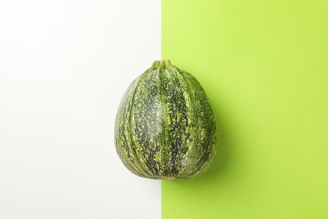 Fresh green zucchini on two tone background