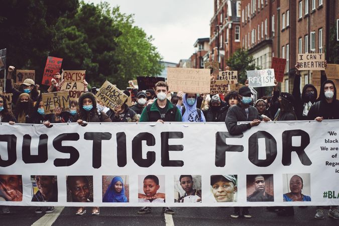 London, England, United Kingdom - June 6th, 2020: Group of protesters marching with banner