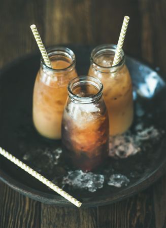 Thai iced tea in glass bottles with eco-friendly straws