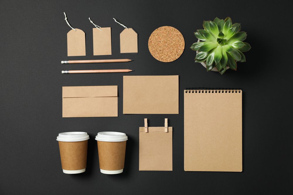 Flat lay composition with blank stationery and succulent on dark background, copy space
