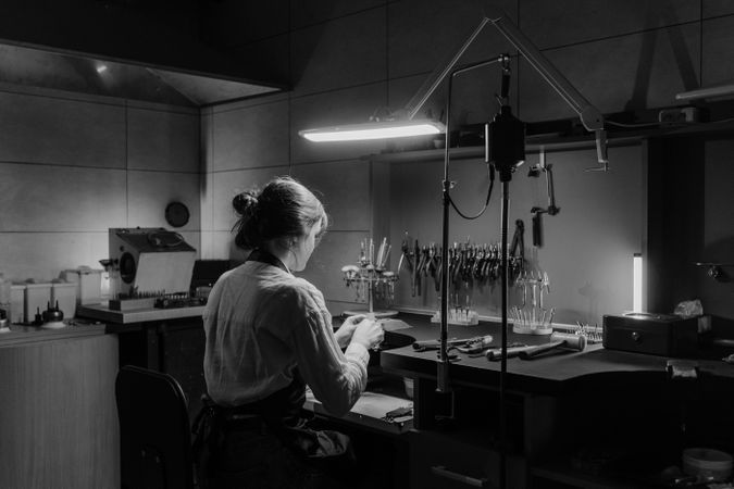 Back view of woman working in a lab in grayscale
