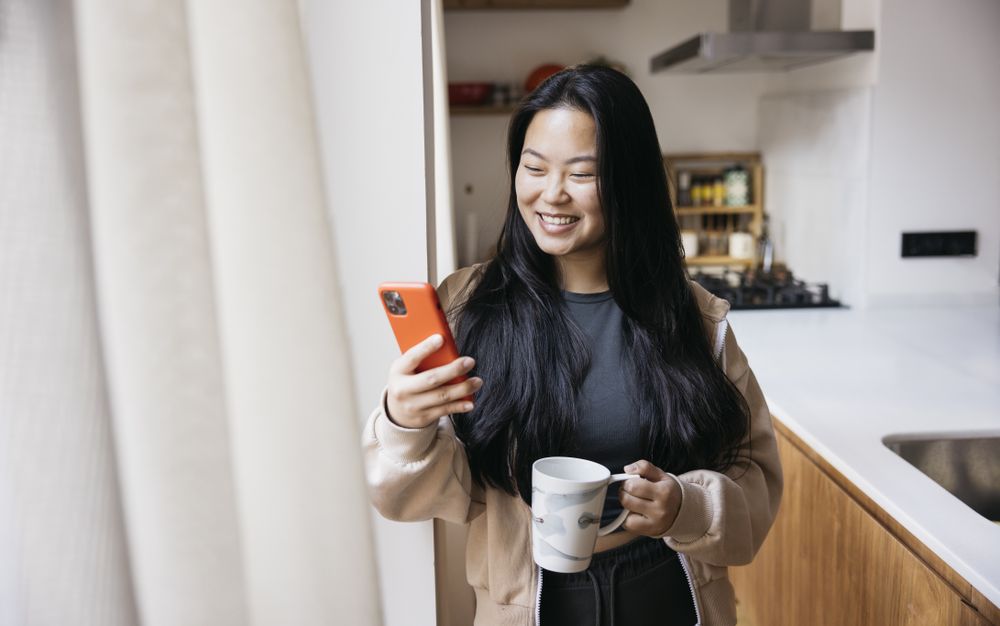 Young woman drinking coffee in a kitchen