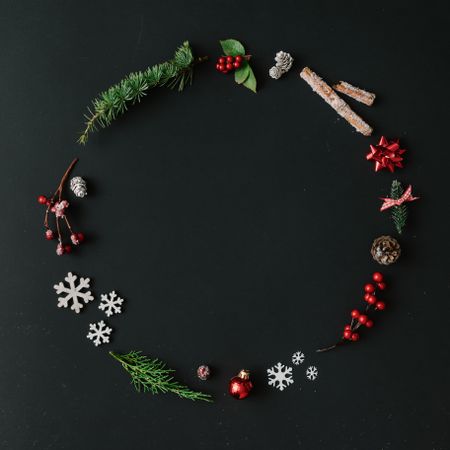 Christmas wreath made of winter items on dark background