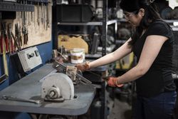 Woman wearing protective glasses working in factory