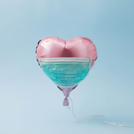 Pink foil heart balloon with protective mask