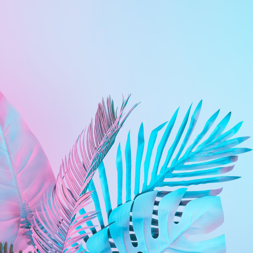 Tropical and palm leaves in vibrant bold gradient holographic colors