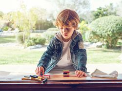 Concentrated kid playing board game