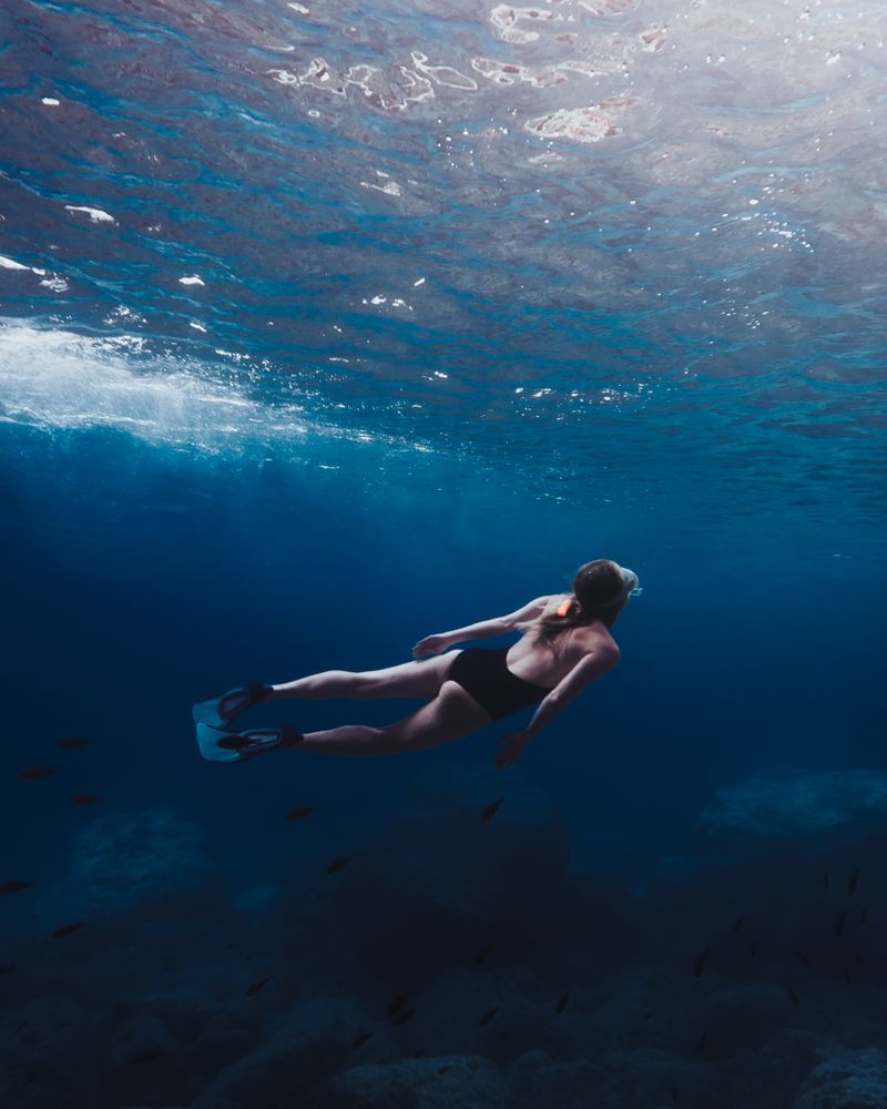 Underwater shot of woman in swimsuit diving