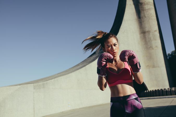 Young muscular woman practicing boxing