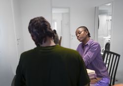 Casual Study Session at Home with Books and Conversation.