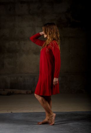Young woman dancing in darkness