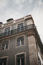 Corner of building against cloudy sky