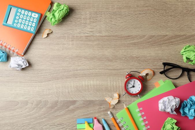 Top view of stationary and notebooks on wooden table with copy space