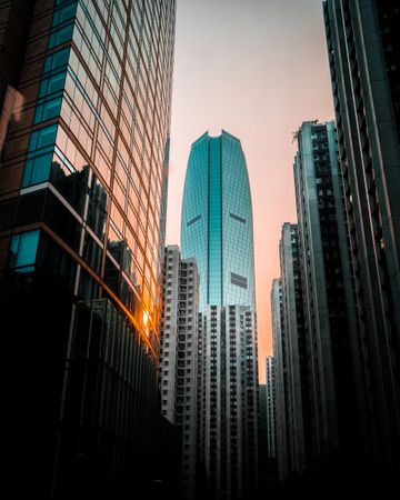 Bottom view of high rise buildings at sunset