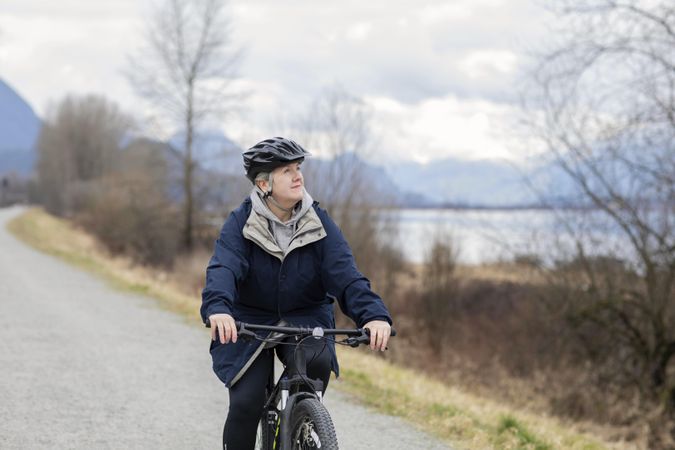 Woman riding a bicycle and looking upwards