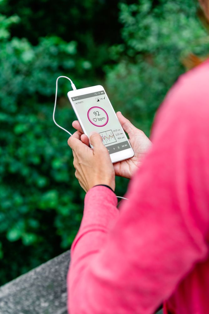 Athlete woman with earphones looking mobile