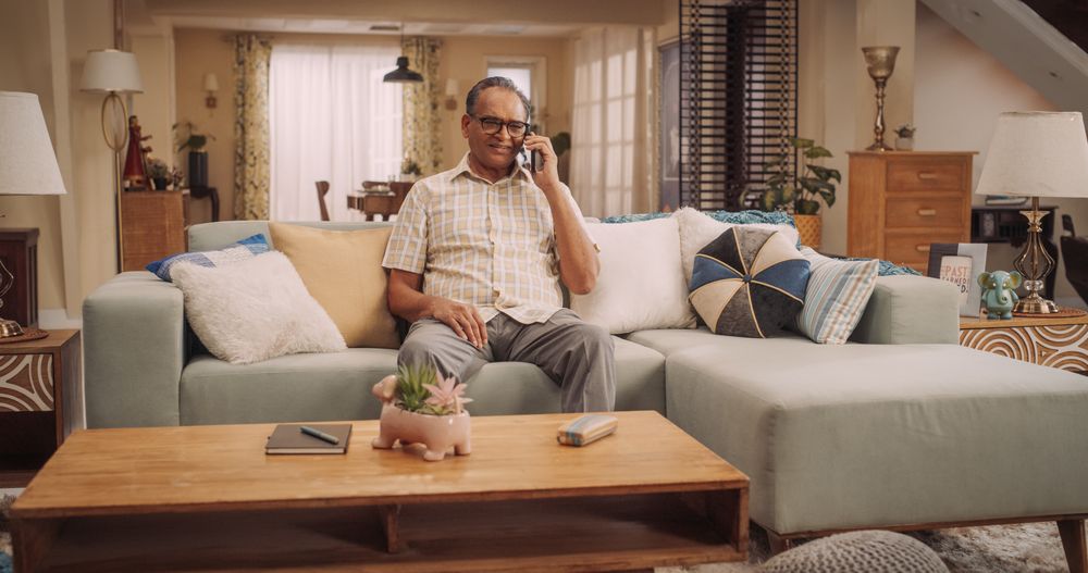 Portrait of Mature Indian Man Using Smartphone, Calling His Friends from Home.